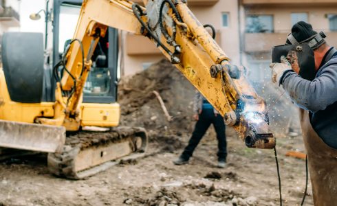 construction-worker-welding-broken-excav